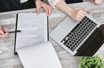 Laptop and documents being reviewed together
